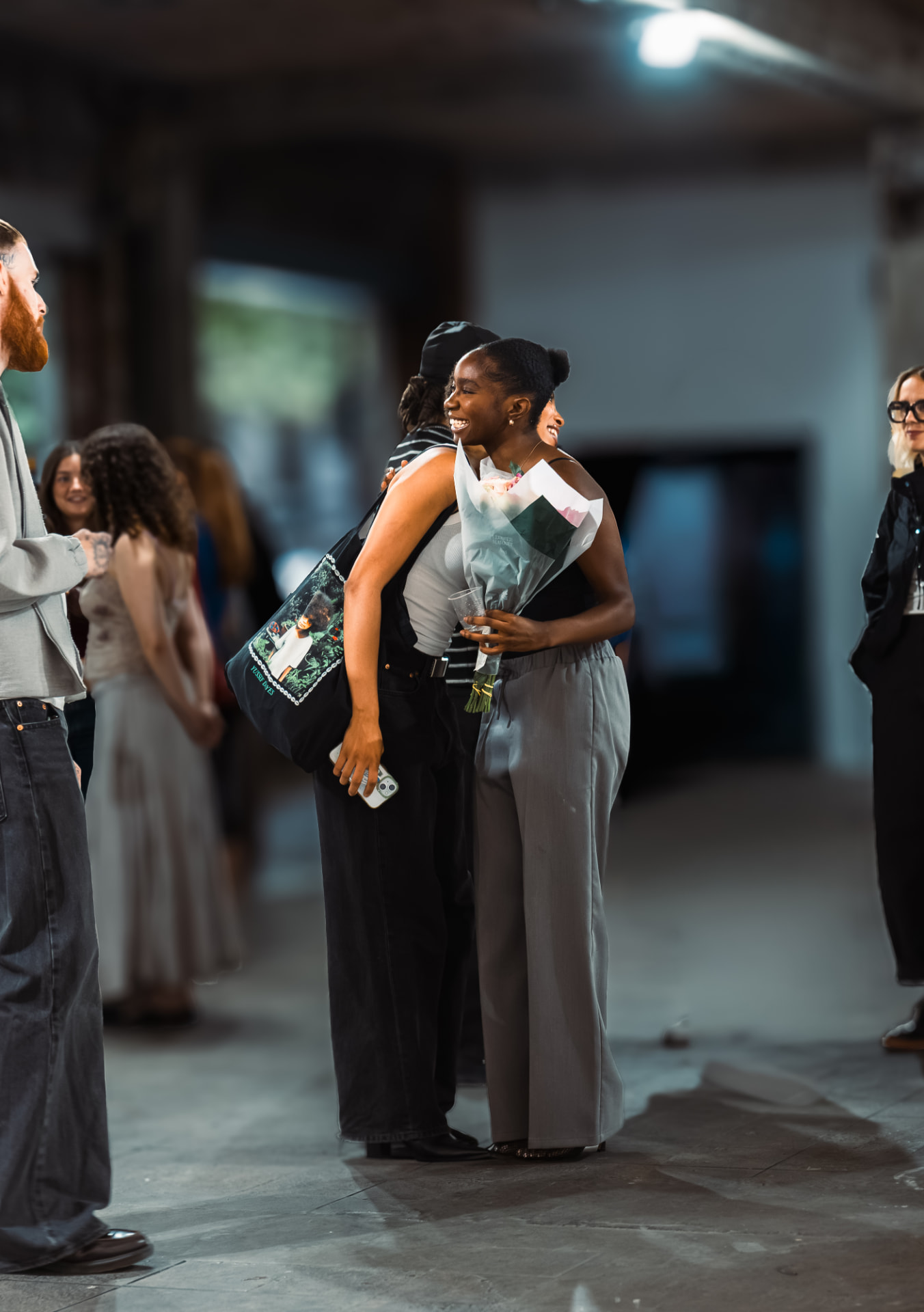 Guest holding a bouquet at a ShadesOf event